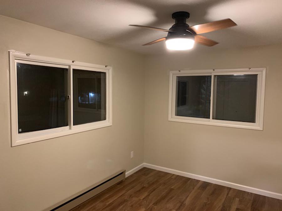 Freshly painted empty room with wood flooring